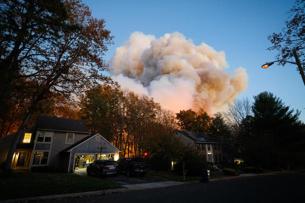 Smoke is seen near homes 