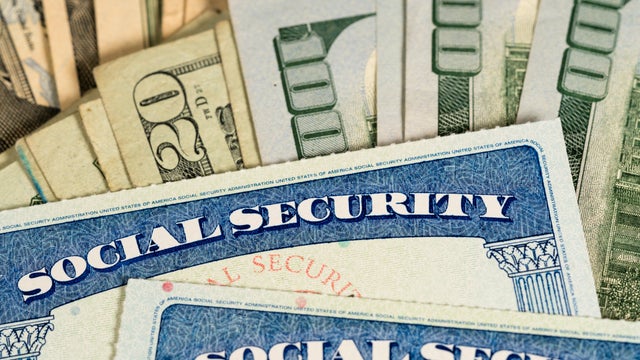 USA Social security cards laid on dollar bills