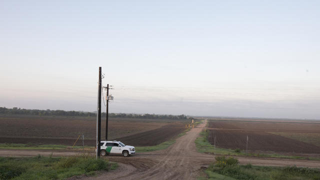 MCALLEN, TX - JUNE 25: A Border Patrol vehicle stops on a farm 