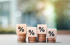 Interest rate finance and mortgage rates. Wooden block with percentage sign on many level of stack of coin. Financial growth, interest rate increase, inflation, sale price and tax rise concept. 