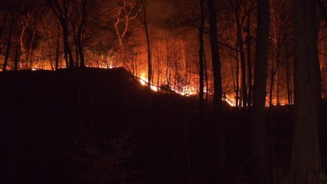 Firefighters knock down a hotspot at the Greenwood Lake fire on November 15, 2024 in Greenwood Lake, New York. 