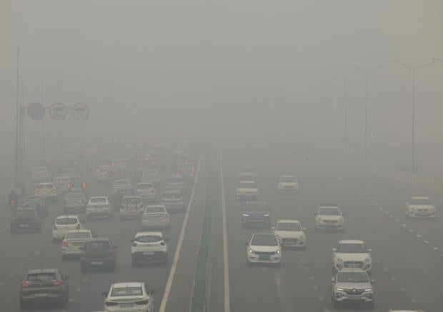 Traffic passes on a road as the sky is enveloped with smog after Delhi's air quality turned "severe" due to alarming air pollution, in New Delhi 