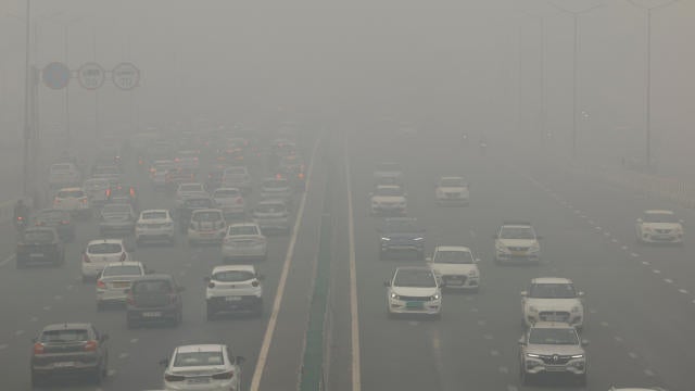 Traffic passes on a road as the sky is enveloped with smog after Delhi's air quality turned "severe" due to alarming air pollution, in New Delhi 