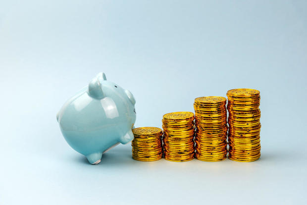 Piggy Bank Climbing Stack Of Coins 