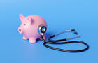 Black stethoscope on the body of a pink piggy bank in blue background. Illustration of the concept of financial health and long-term sustainability of a company 