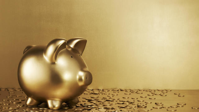 Gold piggy bank with gold coins 