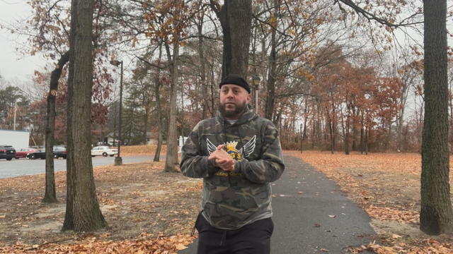 Jared Dotts taking a walk outside on a walking trail 