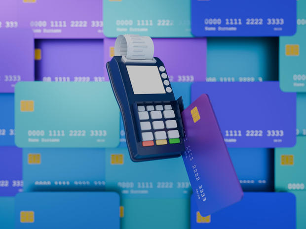 Credit card reader in use, background filled with credit cards, render 