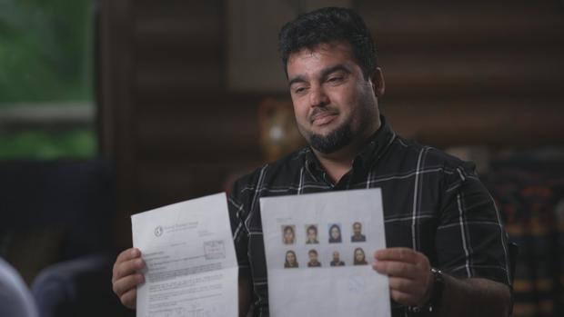 Rahim Rauffi holding his family boarding pass 