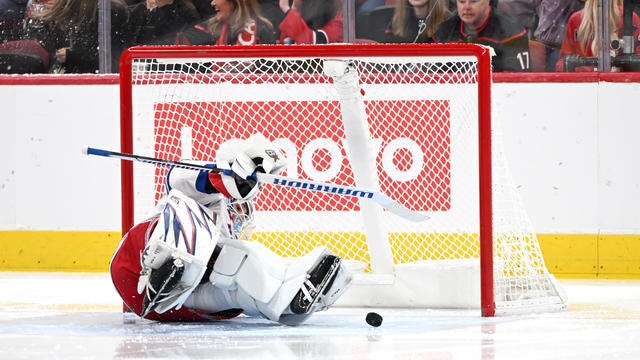 New York Rangers goalie Igor Shesterkin (31) falls in the crease as a shot on goal is taken during the NHL game between the New York Rangers and the Carolina Hurricanes on November 27, 2024 at Lenovo Center in Raleigh, North Carolina. 