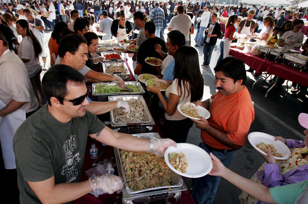 Left, Volunteer Mike Warren was serving up free Thanksgiving dinners. Frank Garcia, owner of La Cas 