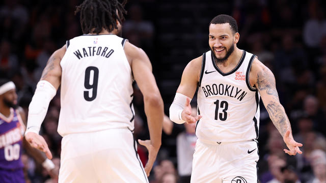 Tyrese Martin #13 of the Brooklyn Nets reacts with Trendon Watford #9 after hitting a three point shot during the second half against the Phoenix Suns at Footprint Center on November 27, 2024 in Phoenix, Arizona. 