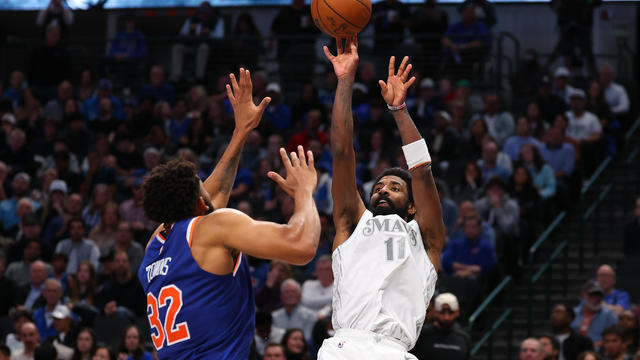 Kyrie Irving #11 of the Dallas Mavericks shoots over Karl-Anthony Towns #32 of the New York Knicks during the second half at American Airlines Center on November 27, 2024 in Dallas, Texas. 