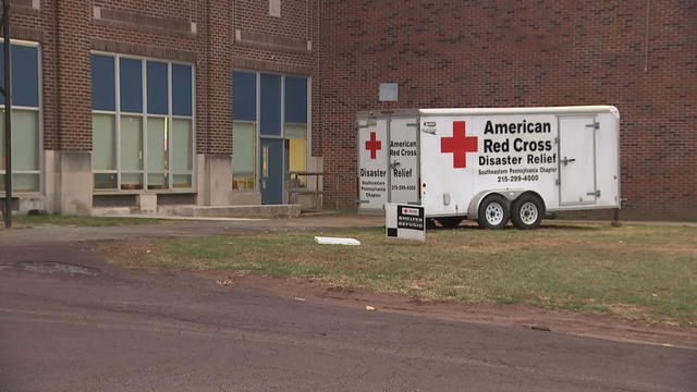 An American Red Cross truck is seen near a brick building 