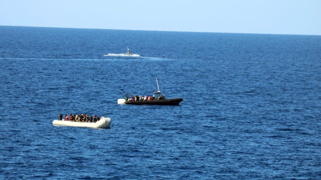 Gunmen in speedboats abduct dozens of women and children from migrants' dinghy off Libya, aid group says