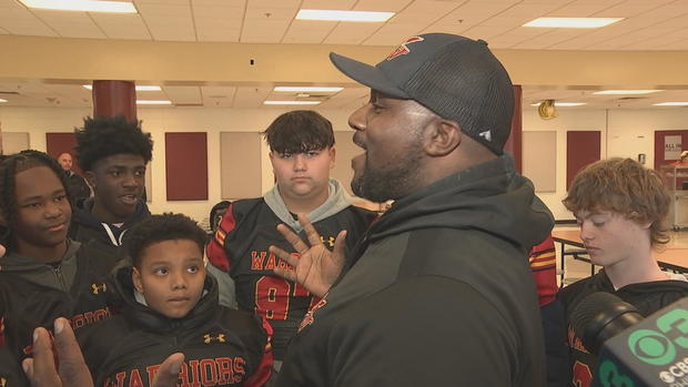 Head coach Brandon Williams speaks to teammates on the Brandywine Warriors 