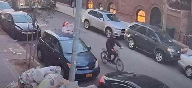 Police are examining surveillance video of what appears to be the suspect at 6:59 a.m. riding a bike on West 85th Street.