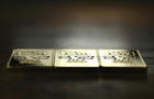 three 1 ounce gold ingots 