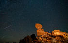 Geminid Meteor Shower over Balanced Rock in Arches National Park in Utah. Composite image shows 24 meteorites over a 2-hour period 