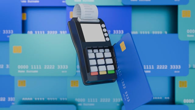 Credit card reader in use, background filled with credit cards, render 