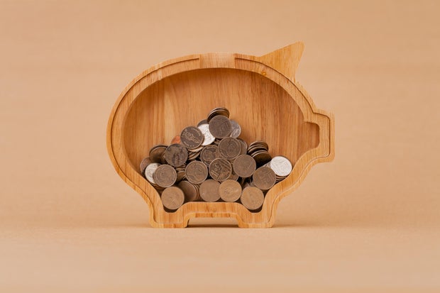 Saving coins in a piggy bank, financial income and financial investment, cash flow from working to earn money