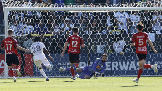 Joseph Paintsil #28 of Los Angeles Galaxy scores the team's first goal against Carlos Coronel #31 of New York Red Bulls during the 2024 MLS Cup Final at Dignity Health Sports Park on December 07, 2024 in Carson, California. 