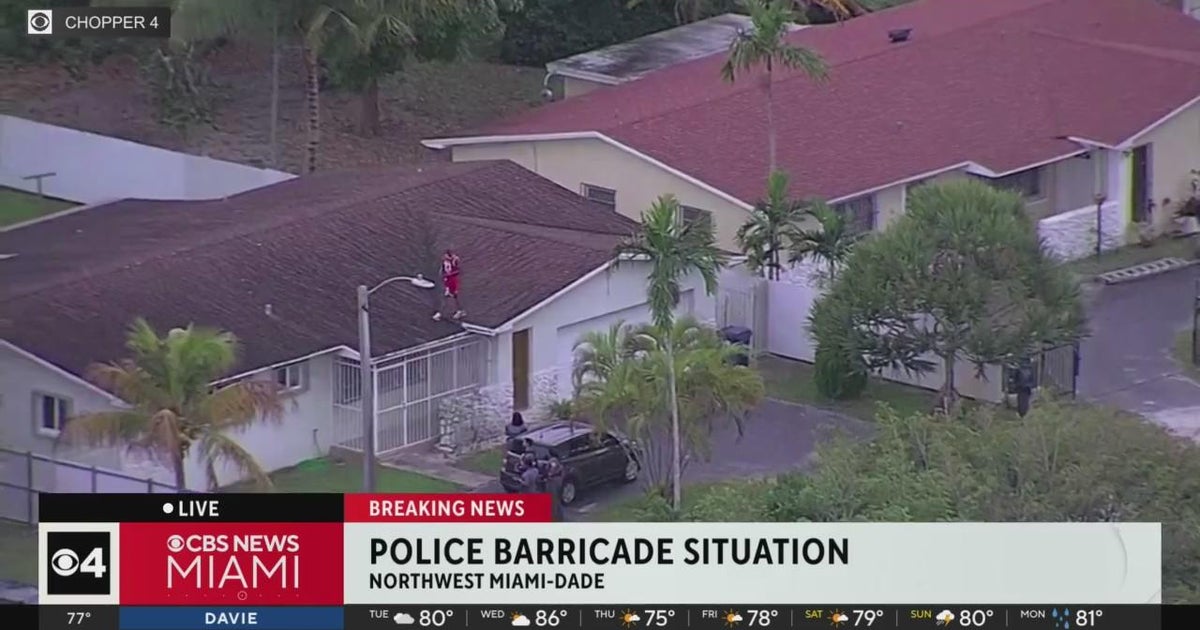 Police try to get man to come down from Miami roof - CBS Miami