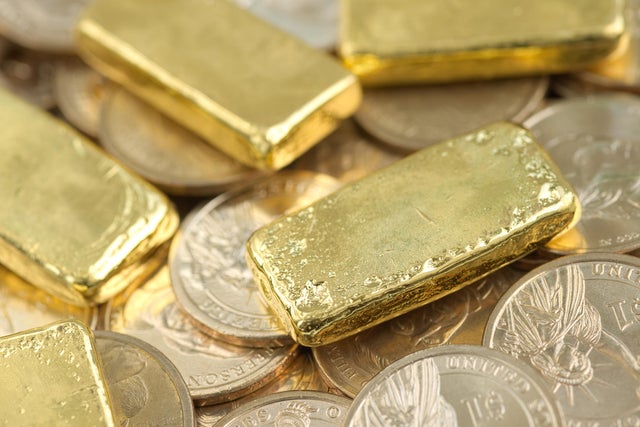 Gold bar over dollar coins