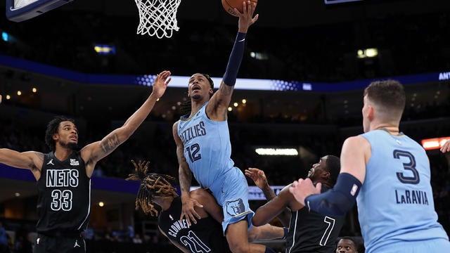 Ja Morant #12 of the Memphis Grizzlies goes to the basket against Noah Clowney #21 of the Brooklyn Nets during the second half at FedExForum on December 13, 2024 in Memphis, Tennessee. 