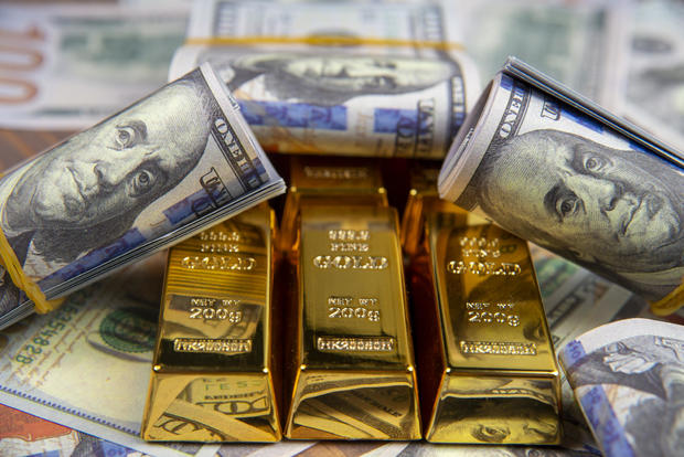 American currency Dollar and Gold ingot combinations. Close up for dollar and gold ingot 