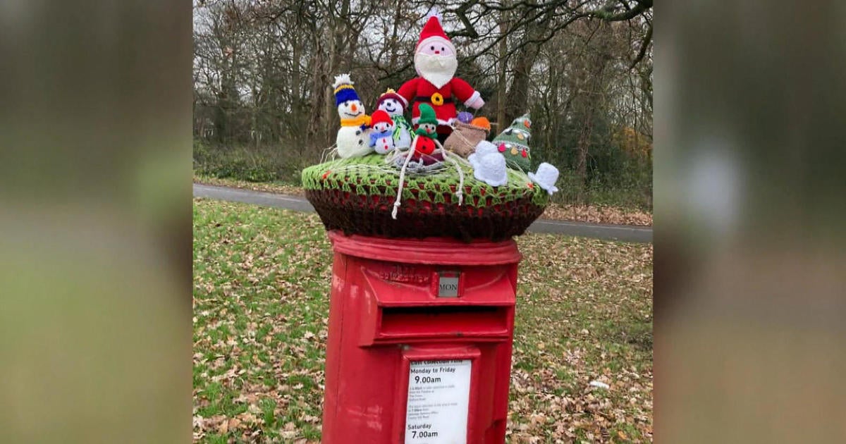 Britain's iconic red mailboxes get holiday decorations