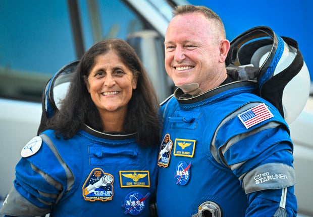 NASA astronauts Sunny Williams, left, and Butch Wilmore, wearing Boeing spacesuits, depart from the Neil A. Armstrong Operations and Checkout Building at Kennedy Space Center in Florida on June 5, 2024.