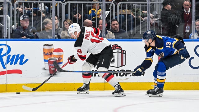 St. Louis Blues right wing Alexey Toropchenko (13) tries to knock the puck off the stick of New Jersey Devils left wing Ondrej Palat (18) during a regular season game where the St. Louis Blues hosted the New Jersey Devils on Tuesday December 17, 2024, at the Enterprise Center in St. Louis MO 