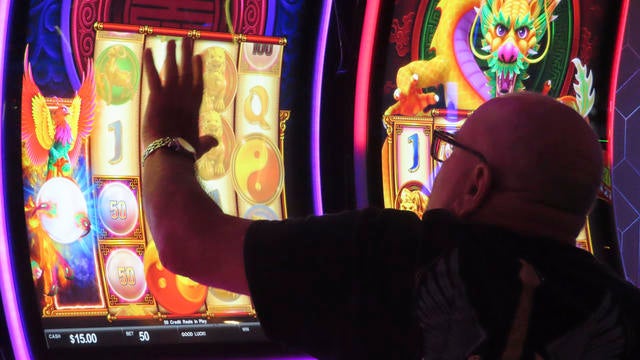 A person uses a slot machine at the Hard Rock casino in Atlantic City in 2022 