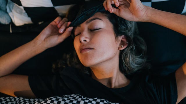 Woman waking up in bed in morning 