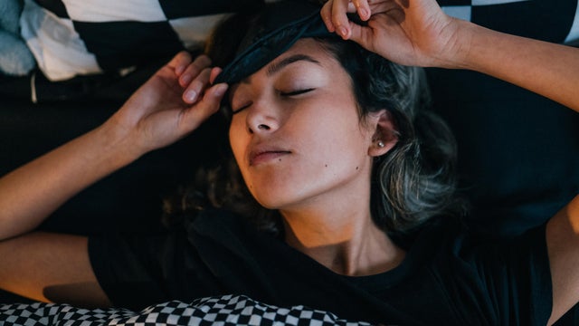 Woman waking up in bed in morning