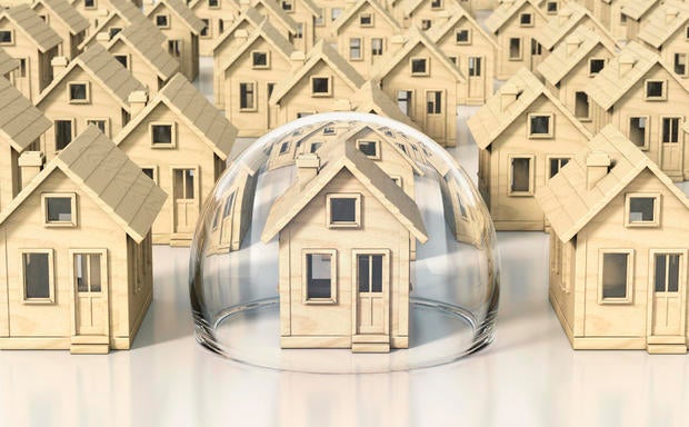 Toy wooden miniature houses, one under glass dome 