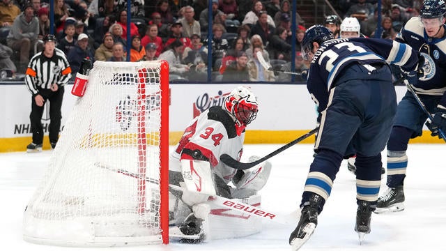 Sean Monahan #23 of the Columbus Blue Jackets shoots the puck against Jake Allen #34 of the New Jersey Devils during the second period at Nationwide Arena on December 19, 2024 in Columbus, Ohio. 