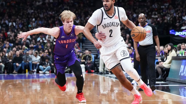 Cameron Johnson #2 of the Brooklyn Nets drives against Gradey Dick #1 of the Toronto Raptors during the first half of their basketball game at the Scotiabank Arena on December 19, 2024 in Toronto, Ontario, Canada. 