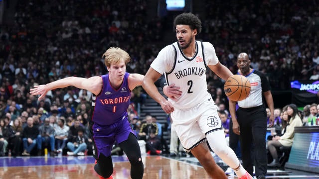 Cameron Johnson #2 of the Brooklyn Nets drives against Gradey Dick #1 of the Toronto Raptors during the first half of their basketball game at the Scotiabank Arena on December 19, 2024 in Toronto, Ontario, Canada. 