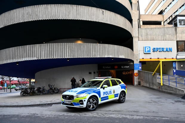 A police car  stands near a parking garage where rapper Gaboro was shot dead on Thursday evening, in central Norrkoping 