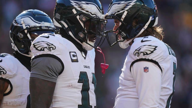 Philadelphia Eagles wide receiver A.J. Brown (11) celebrating his touchdown with teammate quarterback Kenny Pickett (7) - they're standing close together, facing each other 