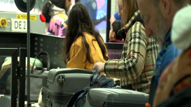 Travelers put their bags on the TSA conveyer belt 