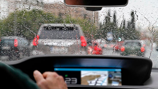 View from car with rain drops of traffic jam in the street 