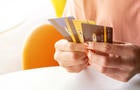 Cropped shot view of female hands holding her credit cards. 