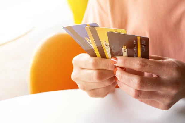 Cropped shot view of female hands holding her credit cards. 