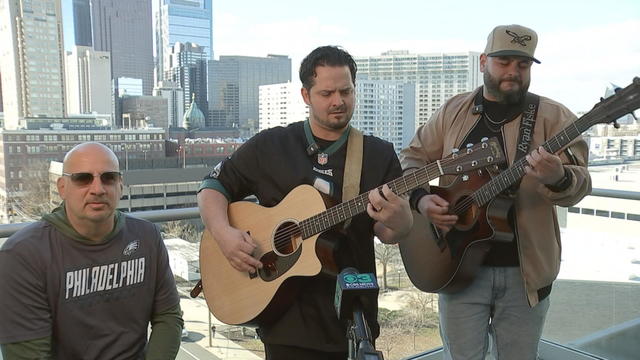 The band performs in front of a CBS News Philadelphia microphone 