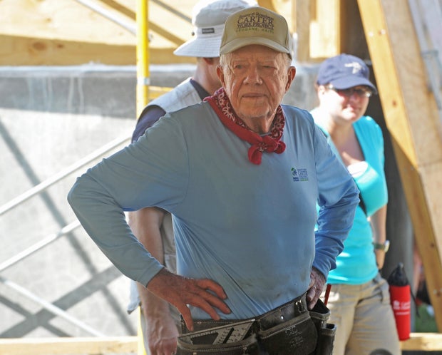 Jimmy Carter helps build a house at Habitat for Humanity construction site for victims of Haiti's 2010 earthquake,