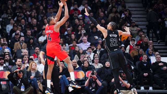 Scottie Barnes #4 of the Toronto Raptors shoots against Jalen Wilson #22 of the Brooklyn Nets during the first half at the Scotiabank Arena on January 1, 2025 in Toronto, Ontario, Canada. 