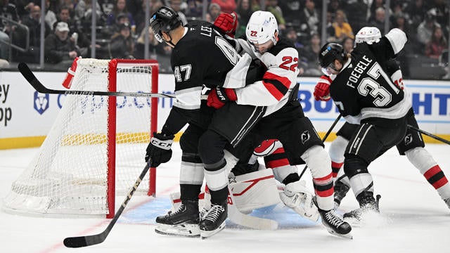 New Jersey Devils Defenceman Brett Pesce (22) and Los Angeles Kings Left Wing Andre Lee (47) battle for position in front of New Jersey Devils Goalie Jake Allen (34) during a Los Angeles Kings game versus the New Jersey Devils on January 1st, 2025, at the Crypto.com Arena in Los Angeles, CA. 